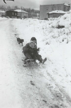 Kit and Dora Dobie sliding on Brown's hill, Kearns, Ont., about 1950